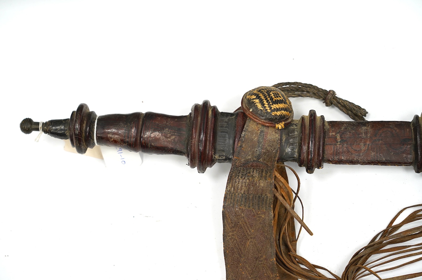 A late 19th century Nigerian Taboura from the Hausa People of Northern Nigeria, in leather scabbard, blade 59.5cm. Condition - good